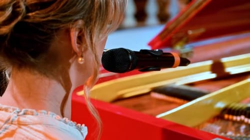 Woman Playing Red Grand Piano with Microphone
