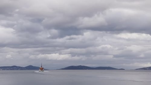 Ferries, boats, sailboats, birds, breakwater, pier, waves in the sea in cloudy weather in autumn
