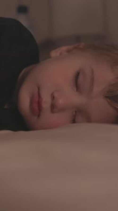 Sleeping Child Relaxing Peacefully on a Bed