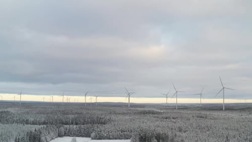Amazing wind farm landscape during winter full of snow with wind turbines and windmill generators pr