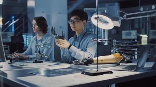 Futuristic Prosthetic Robot Arm Being Tested by a Professional Japanese Development Engineer in a H