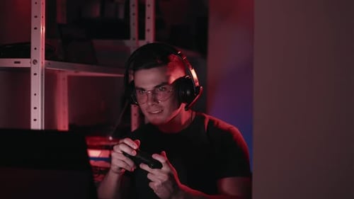 Excited Young Adult Gamer Playing Video Game