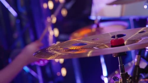Drummer Plays Hi-Hat Under Colorful Stage Lights
