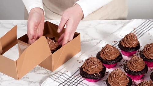 Packaging Chocolate Cupcakes with Chocolate Ganache Frosting Into a Paper Cupcake Box