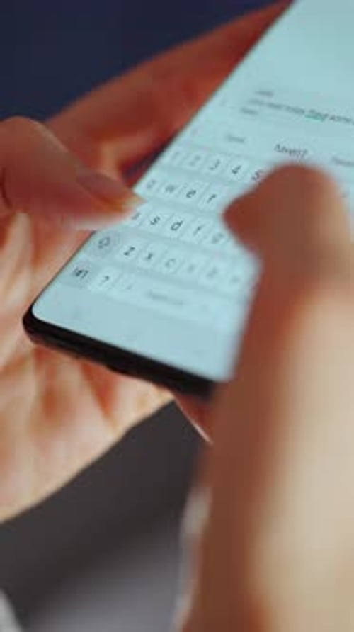 Close Up of Hands Typing on Smartphone Keyboard