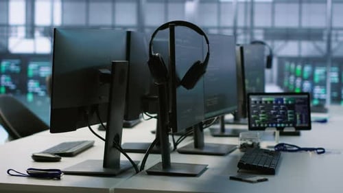 Modern Office with Computers Displaying Code