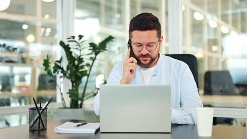 Smiling Professional Male Communicating on Smartphone in Bright Office