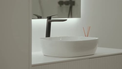 Modern bathroom sink with black faucet and white basin interior