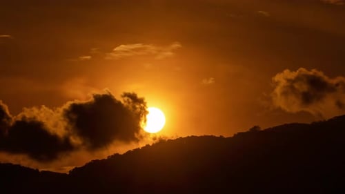 Golden Sunrise Time-Lapse Over Dark Mountain
