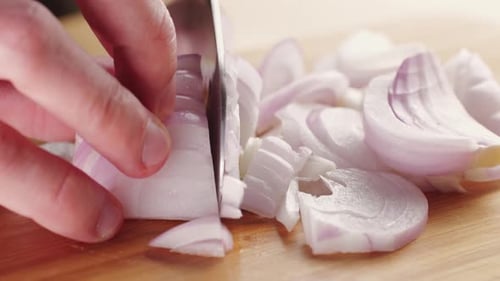 Chef Chopping a Red Onion with a Knife on the Cutting Board Macro Close Up of Cutting Red Onion on