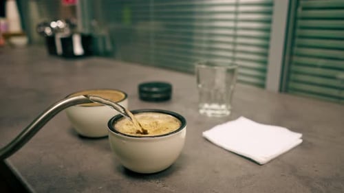 Closeup at Coffee Roasting Factory a Tester Stands in the Kitchen and Pours Boiling Water Into Bowls