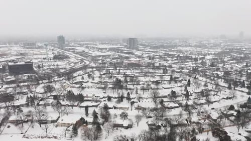 Aerial, rural neighborhood suburb during winter, houses covered in snow