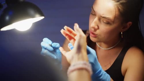 Young Woman Giving Manicure in Beauty Studio