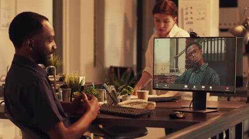 Two Men in an Office Video Conferencing