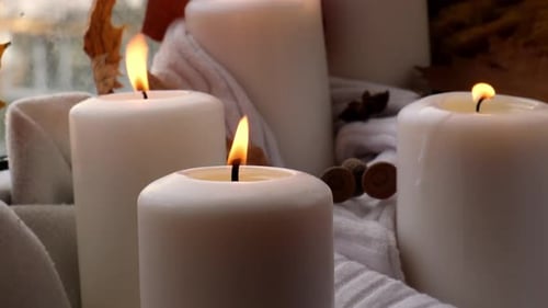 Candles burning with autumn decor
