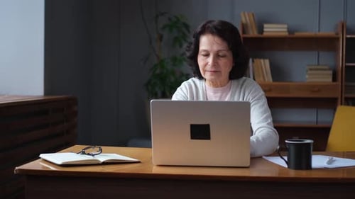 Confident Stylish European Middle Aged Senior Woman Using Laptop at Home Stylish Older Mature 60s