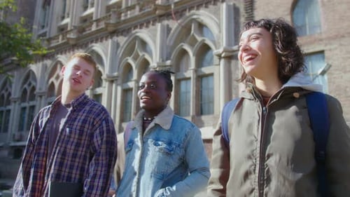 College Students Walking Outdoors on Campus and Having Discussion