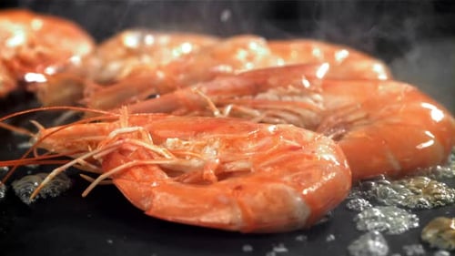 The Shrimp is Fried in a Pan with a Splash Filmed on a Highspeed Camera at 1000 Fps