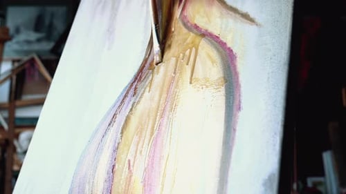 Beautiful woman painting with watercolors at an art gallery workshop