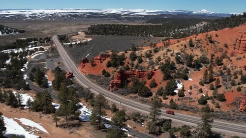 Aerial View of Red SUV Vehicle Moving on Scenic State Route in Countryside of Arizona USA on Sunny W