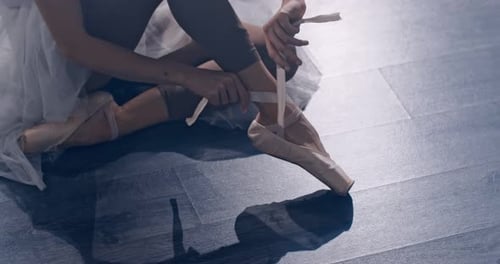 Ballerina Prepares for Training and Puts on Pointe Shoes The Studio Has Soft Diffused Light and