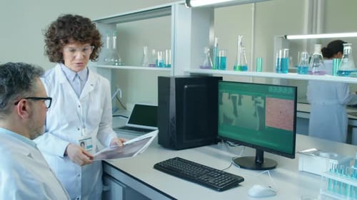 Scientists Collaborating in Modern Laboratory Setting