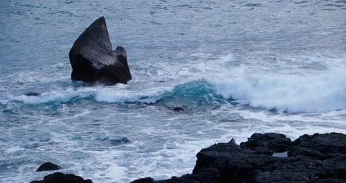 Wave crashing on remote volcanic basalt shore in Atlantic ocean island