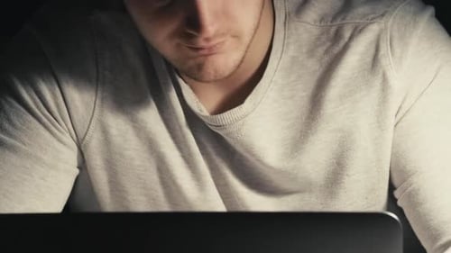 Tired Man Working at Night on Computer