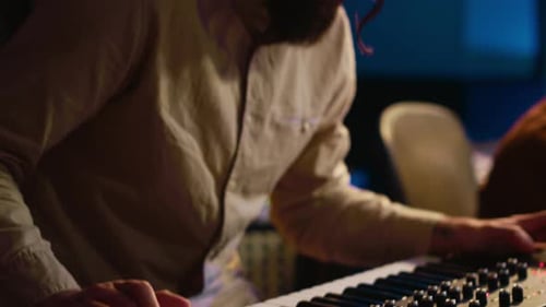 Musician Composer Playing Midi Controller Synthesizer in Professional Studio