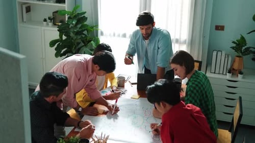 Creative Team Brainstorming Ideas on Whiteboard in Office