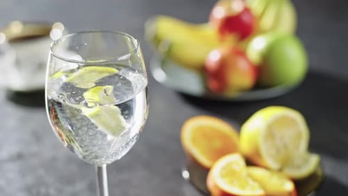 Refreshing Lemon Water with Colorful Fruit Arrangement