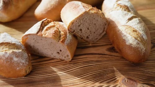 Freshly Baked Bread on Wooden Background in Bakery Shop