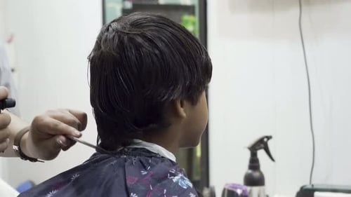 Child Getting Haircut in Barbershop