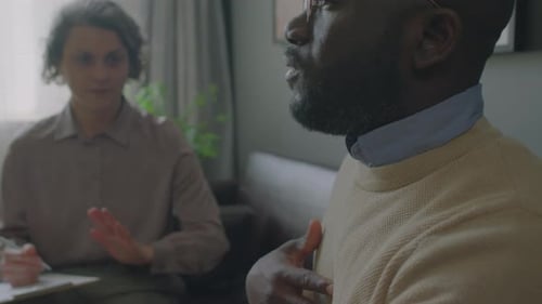 Man and Woman Talking in an Indoor Setting