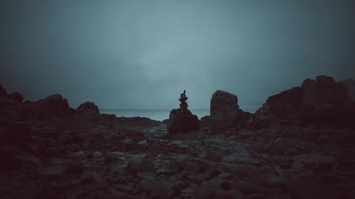 Rock Formations Stand Against a Gloomy Ocean Backdrop at Twilight