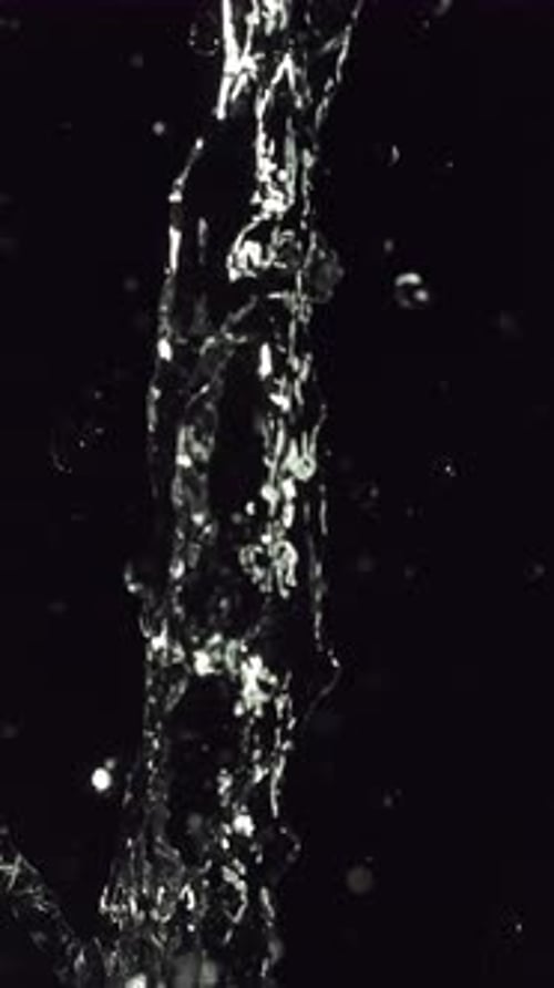 Pouring Water on Black Background