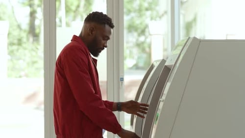 NEW YORK April 5 2018 Focused Young Afroamerican Man Scanning Code with a Smartwatch Withdrawing