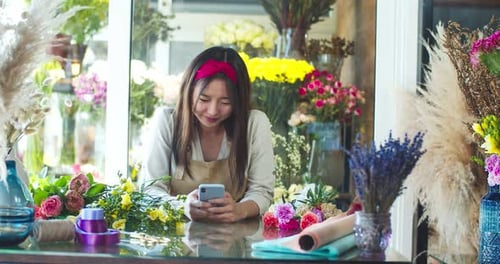 Attractive Asian Female Florist Wearing Apron Working in Flower Store Pretty Young Woman Using