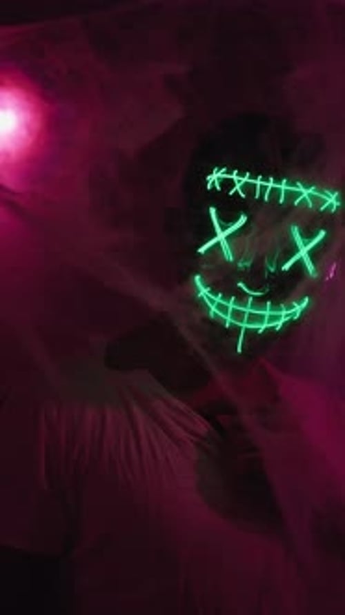 Masked Person Wearing Glowing Neon Smile