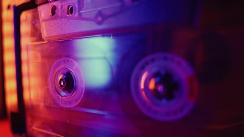 Retro Cassette Tape Spinning in Neon Light