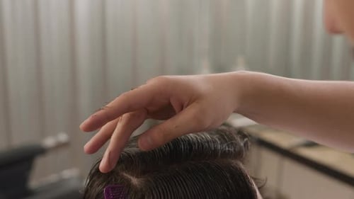 Hands Giving Haircut in Hair Salon