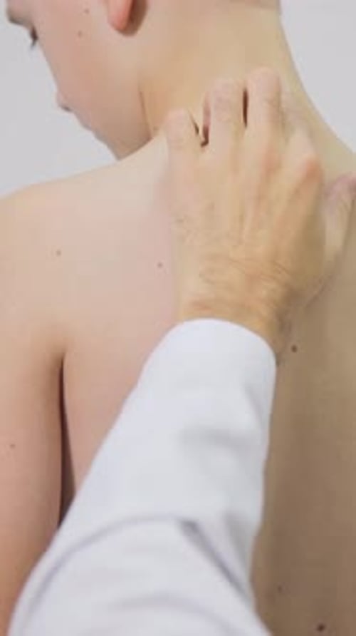 Doctor Examines Child's Back in Medical Office