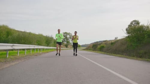 Active Athletic Couple of Friends Running Session Training Outside Multiethnic Team Sportsman and
