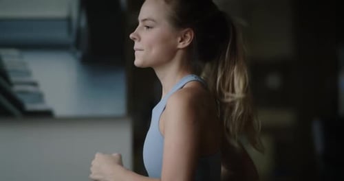 Fitness Woman Running on a Treadmill in the Gym Athlete Uses a Running Machine in a Fitness Center