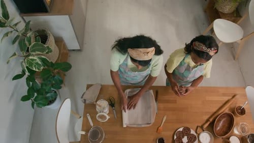Top View of Mother and Child Preparing Tray for Baking Chocolate Cookies