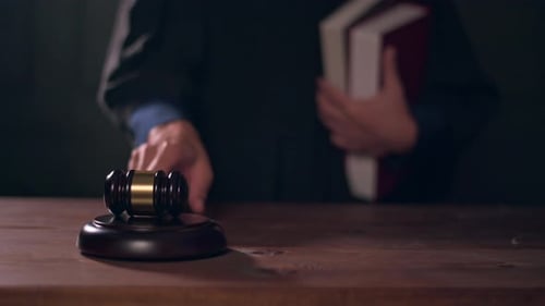 Close up of Judge hand is hitting hammer judge in courtroom