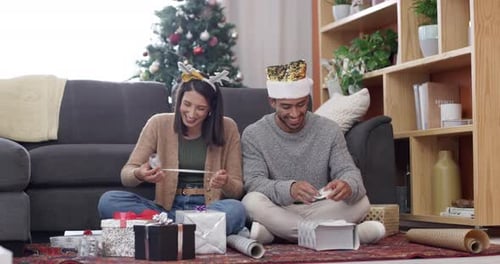 Couple Wrapping Christmas Presents Together at Home