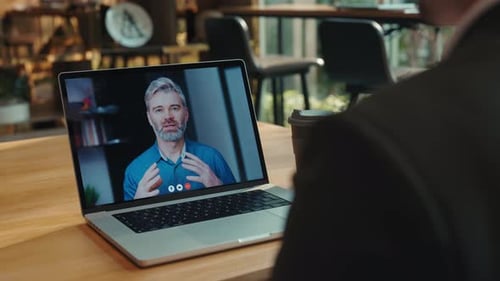 Portrait of Old Businessman Consults Customer on Video Chat Laptop Screen View