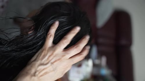 Close Up View Of Back Head Of Female Getting Oil Massaged Into Her Hair And Scalp. Vertical Video, S