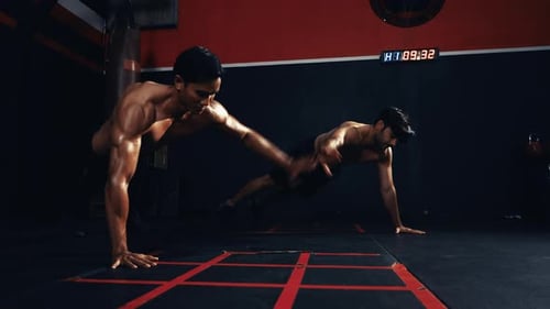 Sportsman workout together exercise push-ups crossfit in the fitness gym